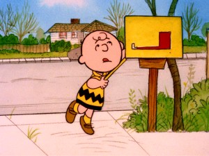 Charlie Brown reaches all the way back into his mailbox to make sure he's not missing any Valentine's Day cards. (He's not.)