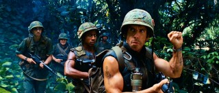 Portraying author and Vietnam War hero "Four Leaf" Tayback, Tugg Speedman (Ben Stiller) leads his boys into the jungle with a clenched fist signal.