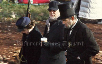 Steven Spielberg directors Daniel Day-Lewis, fully costumed as Abraham Lincoln.