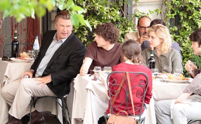 Alec Baldwin shares some words with a table seating Jesse Eisenberg, Greta Gerwig, and Ellen Page.