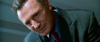 Though he's going for calm and comforting, undertaker Eliot Deacon (Liam Neeson) comes across as anything but as he shares with his patients information about their departure.