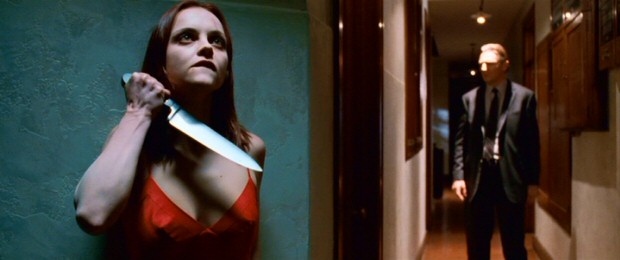 Plotting an escape, Anna (Christina Ricci) wields a knife while awaiting her fastidious mortician "captor" Eliot Deacon (Liam Neeson).