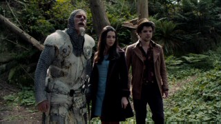 Charlie (Matt Frewer), Alice (Caterina Scorsone), and Hatter (Andrew Lee Potts) survey the Wonderland ruins that disrupt their path in the forest.