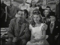 Walt Disney and Kathryn Beaumont marvel at the Magic Mirror's ability to become a television in the 1950 Christmas special "One Hour in Wonderland."