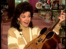 Seen here in the 1993 featurette "Musically Yours, Annette", Annette Funicello is jazzed to rediscover her old Mickey Mouse Club guitar.