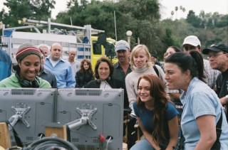 Director Angela Robinson (in ski cap) and Lindsay Lohan watch a scene on the set's monitors.