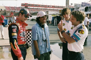From left to right: Jeff Gordon, Angela Robinson, Justin Long, and Breckin Meyer collaborate during filming of the climactic NASCAR scenes.