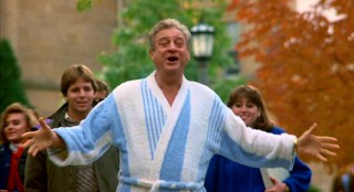 This fall, The Big Man on Campus wears a blue and white bathrobe while looking happy to see his son.