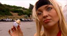 Model/Playmate Irina Voronina has a small part in the film, but does more acting in the featurette "Under the Balls", in which she poses as a quirky "ball wrangler." Here, she shows off a little ping-pong ball with a face and straw hat.
