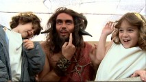 Dressed up like a satyr for the Ancient Rome sequence, Russell Brand goofs around with child actors Jonathan Morgan Heit and Laura Ann Kesling in "To All the Little People."