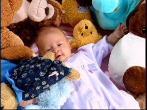 One of the many cute babies seen in this program, but only one of the few to actually be awake and enjoy the Toys R Us goods.