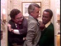 Taylor, the Governor, and Benson squeeze into a tight bathroom because it's the only place in the house that's not been bugged.