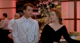 Hard-working executive Susan Lawrence (Elizabeth Perkins) takes an interest in the unique Josh, here at a company party.