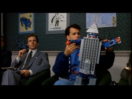 Still from the original Big DVD: Josh tries out Paul's toy pitch - a building that turns into a robot.