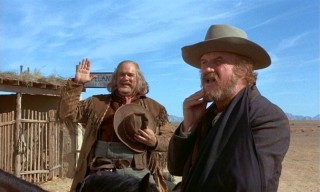 With his mind clearly elsewhere, Marshal Gifford (Jack Warden) nonchalantly swears in eager deputy Copeland (David Huddleston).