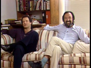 They may not be related, but you'll want to call Albert and James Brooks the Brooks Brothers as they share couch poses, tones, and clothing styles in "Interviews and On-Set Footage."