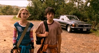 Leslie Burke (AnnaSophia Robb) and Jess Aarons (Josh Hutcherson) walk from their bus stop into the forest that will become their frequent playground.