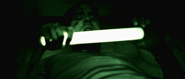 Paul (Ryan Reynolds) is green from the glow of glow sticks he is fortunate enough to have been buried with.
