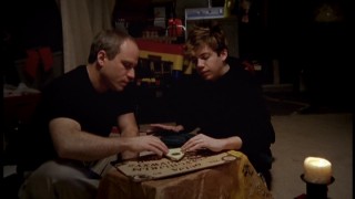 Documentary filmmaker and awkward teen share a Ouija board moment.