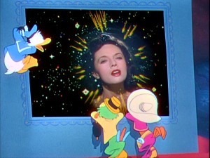 Neon arrows point to the head of Dora Luz, as her singing holds the attentions of Jose, Panchito, and, most of all, Donald. Still from The Three Caballeros: Gold Collection DVD - click to view screencap in full 720 x 480.