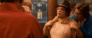 Snork (Jack Doolan), supposedly nicknamed for his olfaction, proudly displays his crude self-illustrated body art of a naked vampire woman.