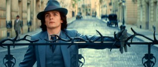 Holding onto the gate to appear casual, Chri (Rupert Friend) is actually quite curious as to Lea's whereabouts.