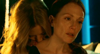 Well, this is different. Catherine (Julianne Moore) gets a passionate neck kissing and more from Chloe, the prostitute she hired to tempt her husband.