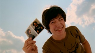 Teenaged smartass Vince Jr. (Ezra Miller) proudly presents Tony's mug shots to his sister.