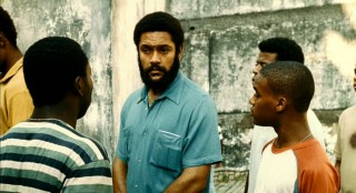 A handful of clues (football player, waiter, the name Heraldo) lead Ace and Wallace to this man (Rodrigo Dos Santos), a parole line queuer who might be Wallace's father.