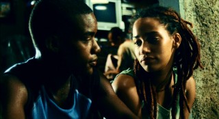 Wallace has an innocent twilight chat with love interest Camila (Nama Silva), while her protective brother Fiel (Luciano Vidigal) remains in sight inside.