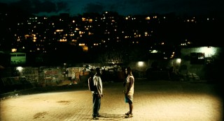 With Rio de Janeiro's scattered lights behind them and gang warfare around them, Ace and Wallace call it a night.