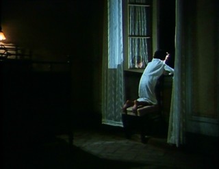 In the middle of the night, this young boy watches the circus tent erected outside his bedroom window at the beginning of Fellini's "I Clowns."
