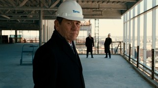 Dissatisfaction in the company he co-founded hangs on the face of Gene McClary (Tommy Lee Jones), as he makes a hard-hatted visit to the new offices' construction site.