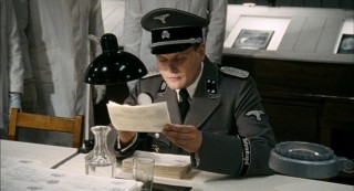Herzog, the very same man who arrested Sorowitsch, now inspects the counterfeited currency for passibility.