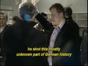 The making-of featurette spends most of its time talking about the back-story but does provide some glimpses behind the scenes, as seen here with Stefan Ruzowitzky providing on-set direction.