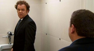 Even at a urinal, John (John C. Reilly) isn't safe from getting caught in the act, as Cyrus confronts him in the bathroom at his ex-wife's wedding.