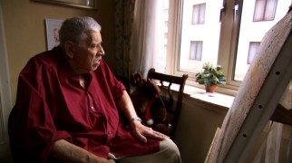 Expatriate Robert "Bob" Sherman leans back from his painting canvas for a look outside his London home.
