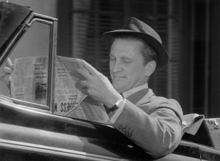 In his introduction, Charles Tatum (Kirk Douglas) pages through the Albuquerque Sun Bulletin while being towed through town.