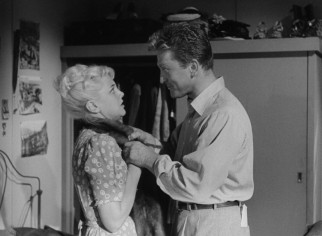 Charles Tatum (Kirk Douglas) presents Lorraine Minosa (Jan Sterling) with a mink stole that's a fifth wedding anniversary gift from her trapped husband.