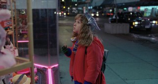 Sara (Maia Brewton) uses an unsupervised moment to check out a toy shop's window, while the bad guys spot her.