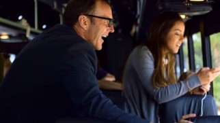 Clark Gregg and Chloe Bennet take a look out the bus window at the excitement awaiting them at San Diego Comic-Con.