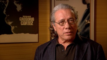 In front of some Edward James Olmos posters, Edward James Olmos recalls shooting his brief "ˇAlambrista!" part and the working relationship born out of that.