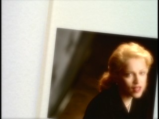 Madonna sings from the turning pages of a scrapbook in the "This Used to Be My Playground" music video.