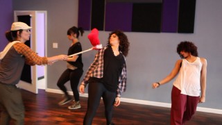A red pillow on a stick fills in for a Chipette in the dance rehearsal of "Everybody Munk Now!"