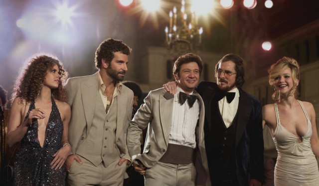 The five principals of "American Hustle" -- Amy Adams, Bradley Cooper, Jeremy Renner, Christian Bale, and Jennifer Lawrence -- share a glitzy walk.