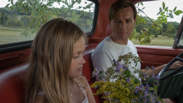 Swede Levov (Ewan McGregor) stops to smell the flowers with his stuttering daughter Merry (Hannah Nordberg) in "American Pastoral."