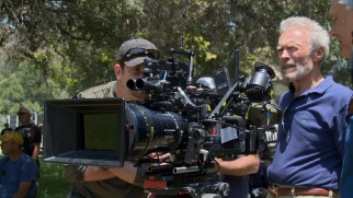 Bradley Cooper sneaks a peek at the shot Clint Eastwood is composing in "One Soldier's Story: The Journey of 'American Sniper.'"