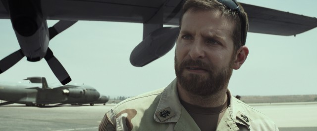 A bearded and bulked-up Bradley Cooper plays sharpshooting Navy SEAL Chris Kyle in "American Sniper."