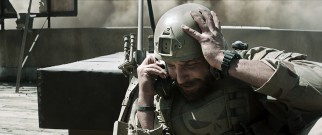 Chris Kyle (Bradley Cooper) checks in with his wife Taya in a distressing phone call.