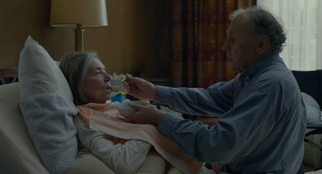In "Amour", Georges Laurent (Jean-Louis Trintignant) spoon-feeds his wife Anne (Emmanuelle Riva) after a stroke leaves her partially paralyzed and highly dependent.